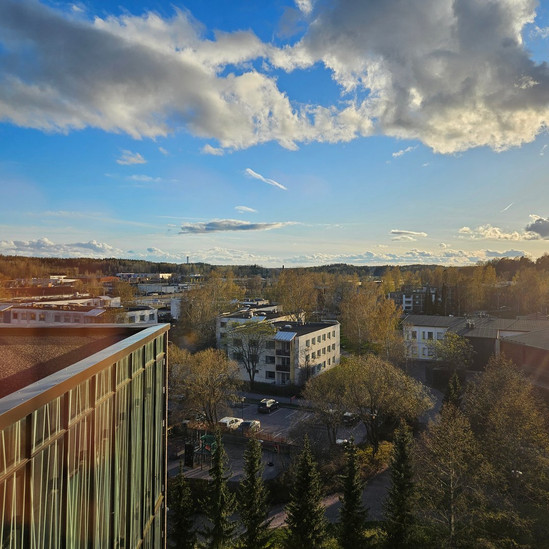 Kirkkonummi's town centre from a high vantage point, with the sun low in the background.