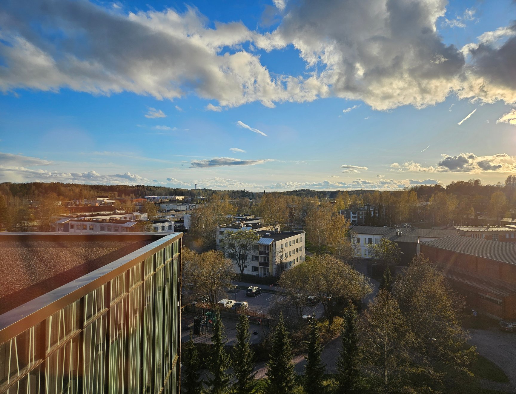 Kirkkonummi's town centre from a high vantage point, with the sun low in the background.