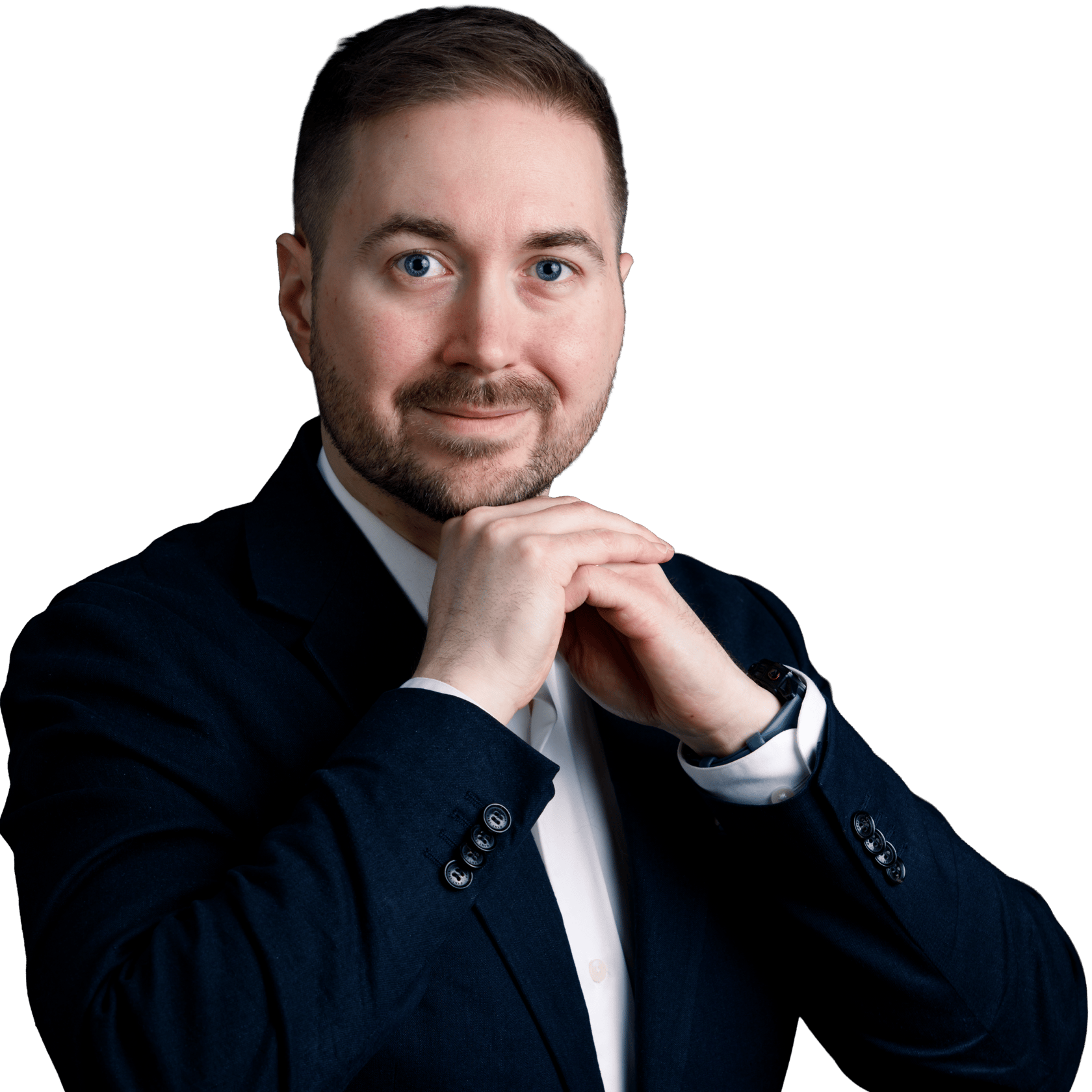Lauri Lavanti resting his hands against each other and looking at the camera with a smile. He is wearing a white dress shirt and a dark blazer. Photo by Erkki Laine.